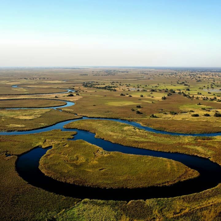 An aerial photograph of Botswana showing the curve of a river.