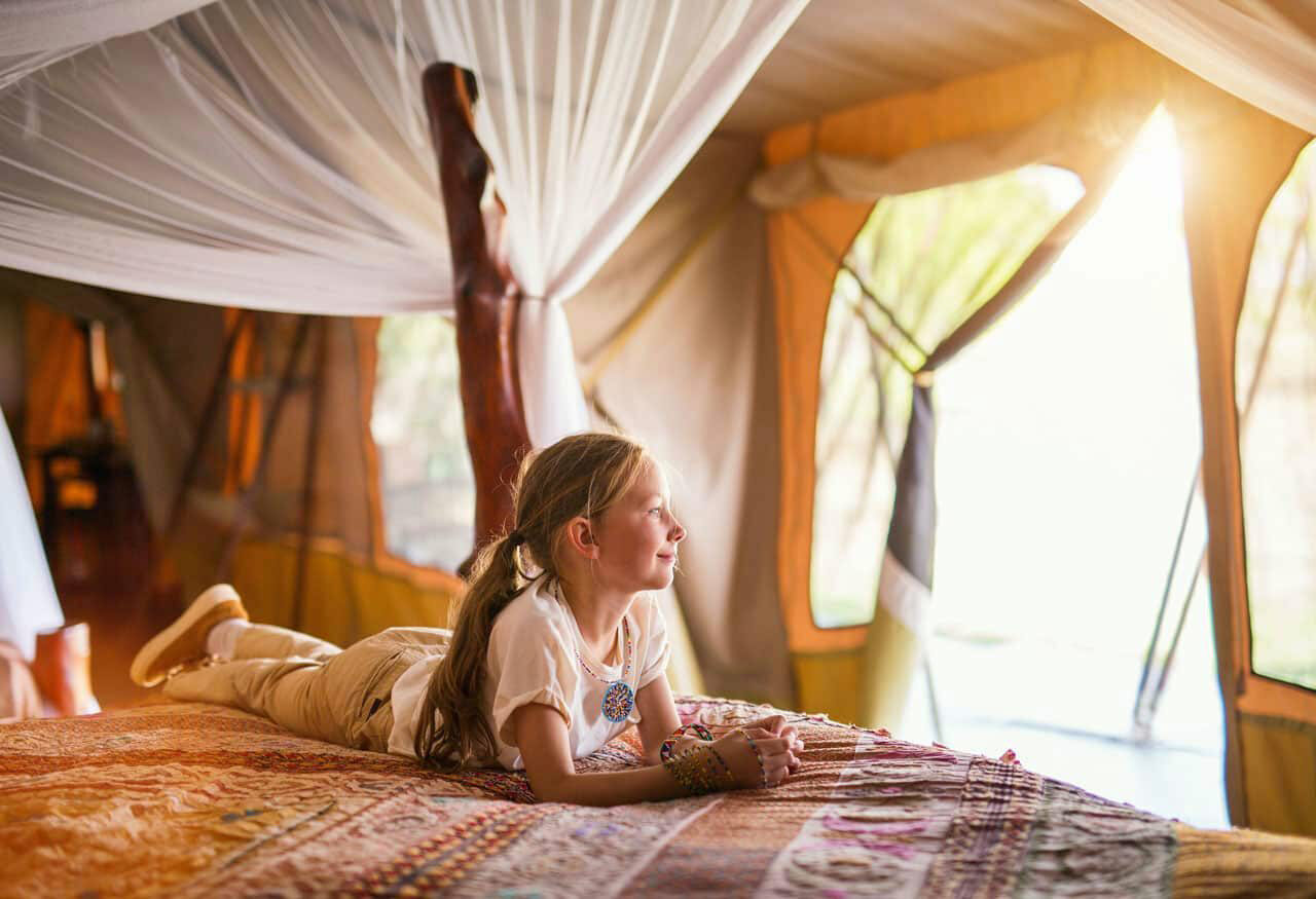 A girl in a safari tent.