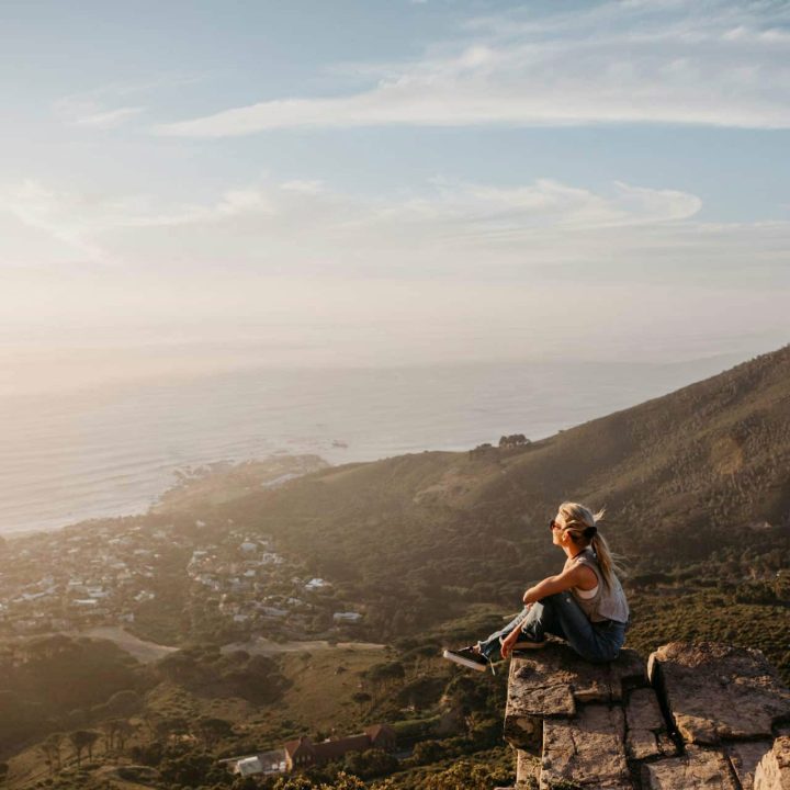 A woman enjoying the view out to sea from altitude.