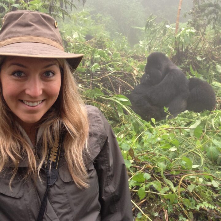 Image of Wendy in Rwanda. Mountain gorillas are in the background.