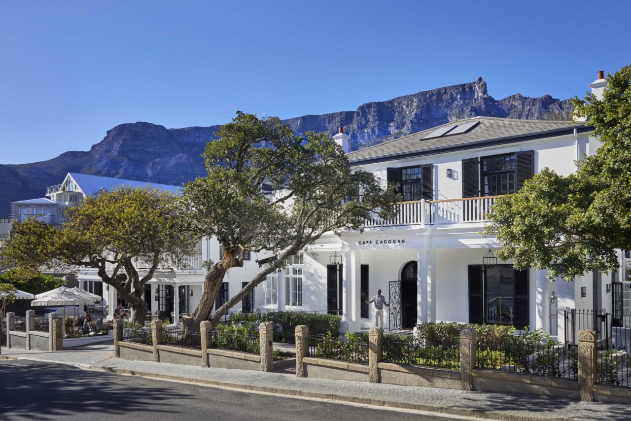The white, black-shuttered facade of Cape Cadogan boutique hotel, a honeymoon safari stay, Cape Town, South Africa.