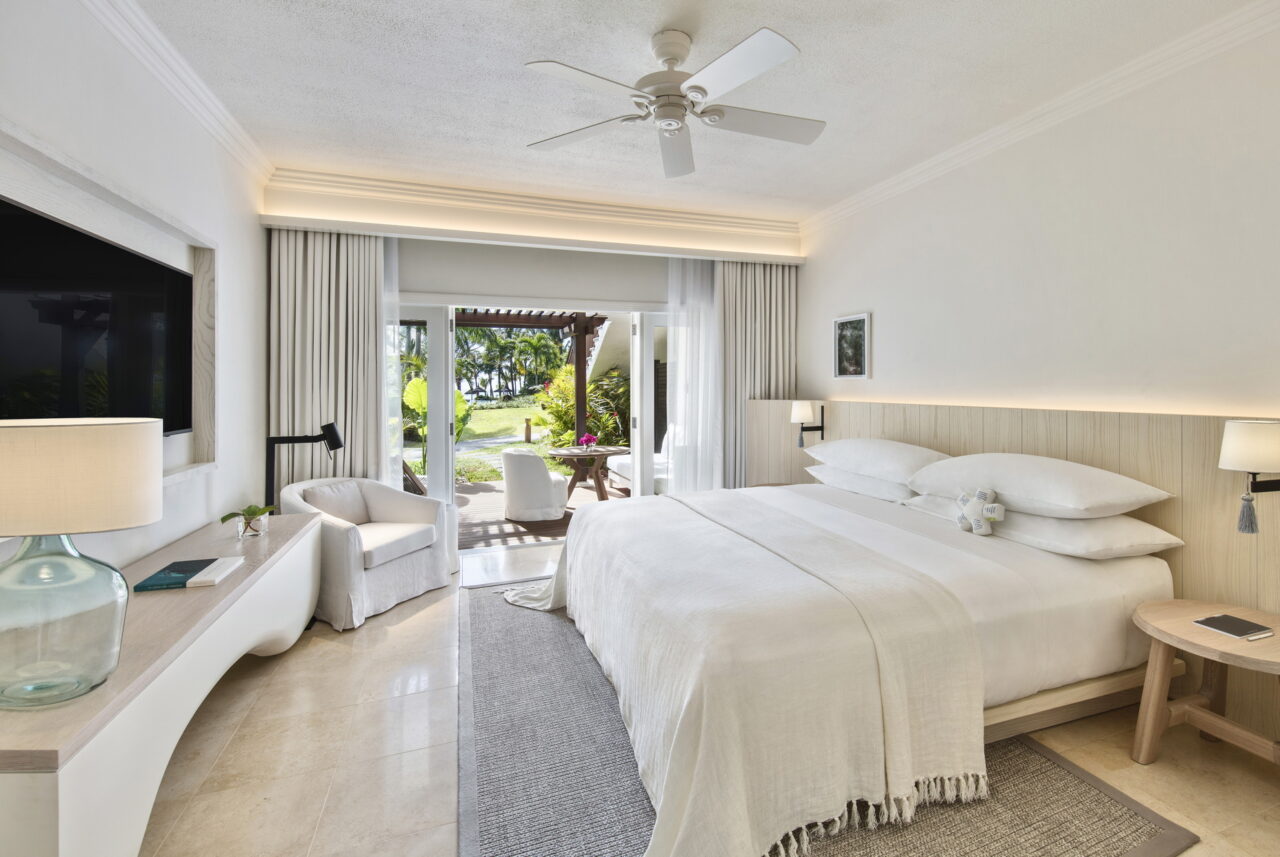 An empty bedroom opens onto a deck overlooking the bush, a honeymoon safari stay, Mauritius.